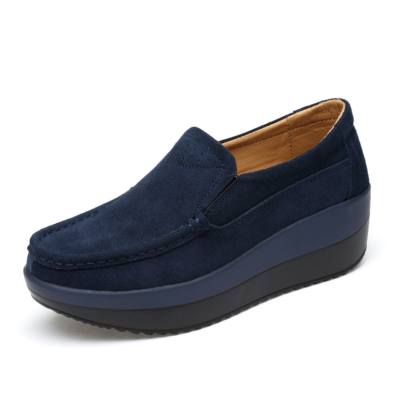 Foto av en blå wedge loafer för kvinnor mot en vit bakgrund