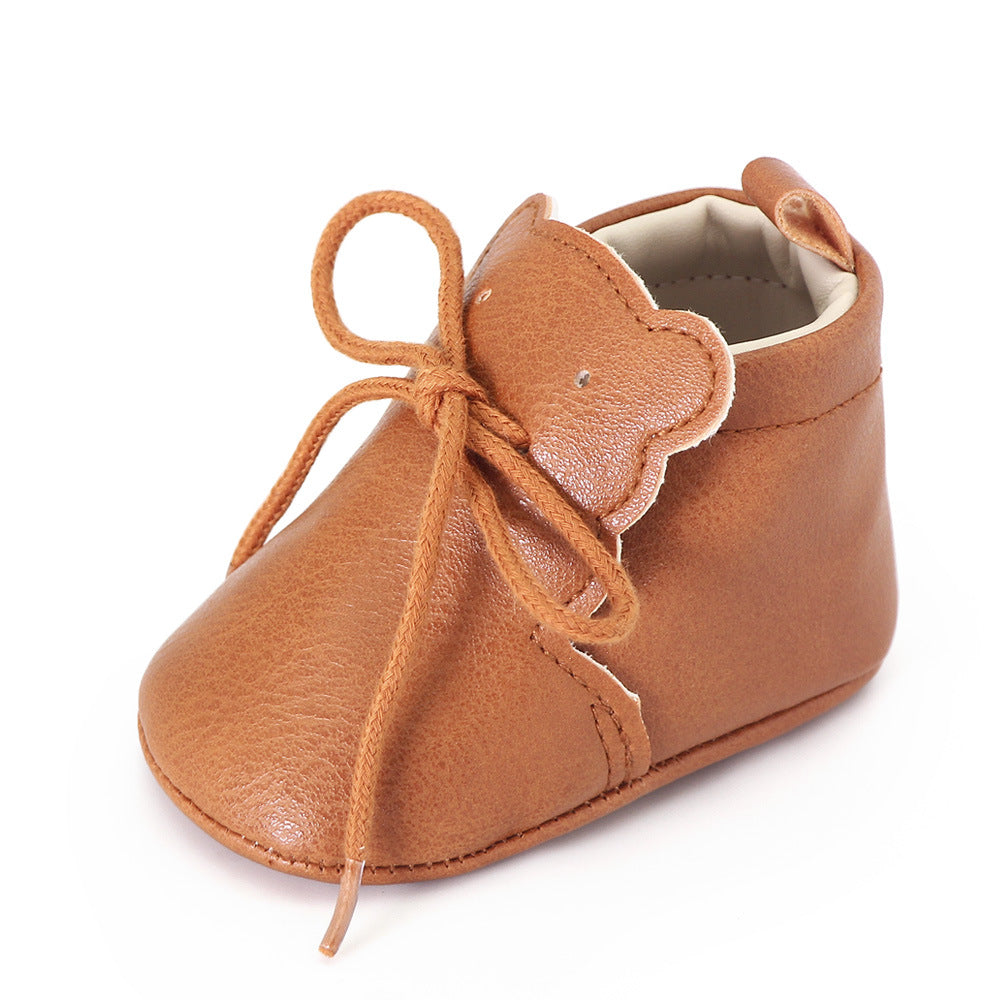 Mjuka bruna loafers med snörning och björntungsdetalj för baby